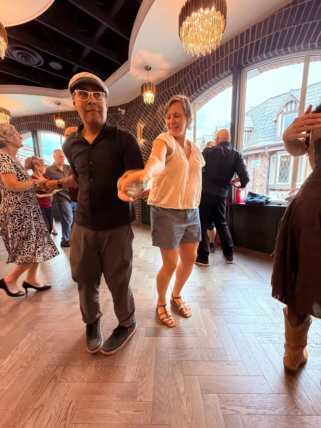 A couple dancing together beside the brick archway at The Grand Hall