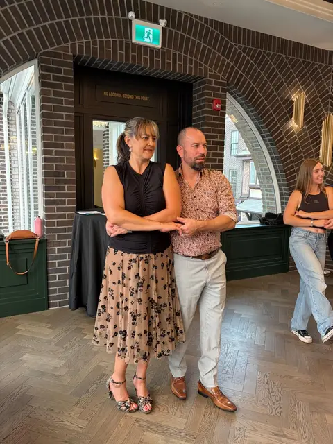 Dancers in the cuddle position during the merengue by the brick arch at Tuesday Salsa Nights, The Grand Hall