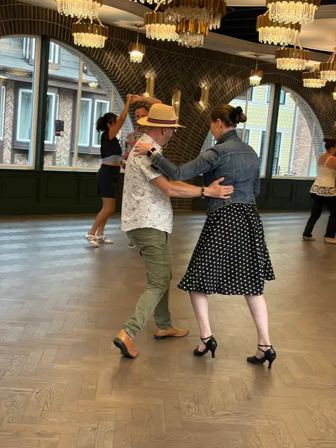 Two dancers mid-turn on the open floor at Tuesday Salsa Nights, The Grand Hall, District 1881