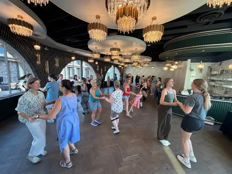 The class rotating partners in a wide circle at Tuesday Salsa Nights, The Grand Hall, Chilliwack BC