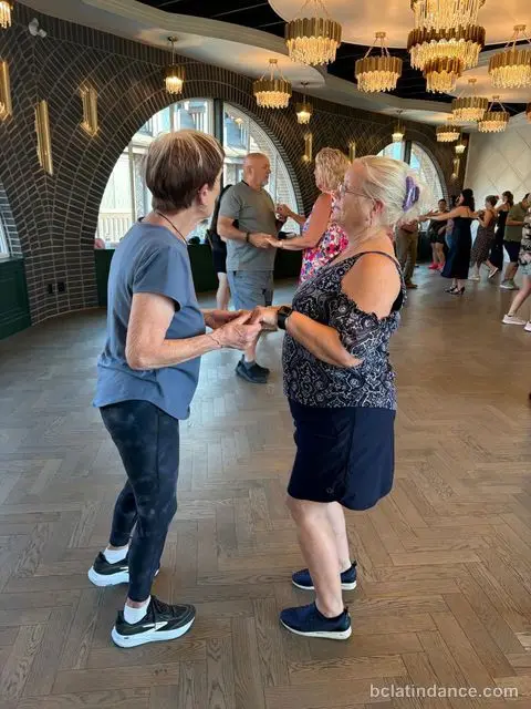 Two women practicing the basic salsa step at Tuesday Salsa Nights, The Grand Hall, Chilliwack