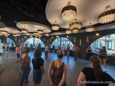 Dancers gathered by the arches and the bar between songs at The Grand Hall, Chilliwack