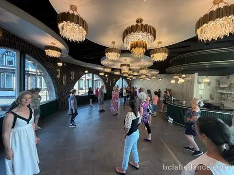 A wide view of the arched windows, chandeliers and dance floor at Tuesday Salsa Nights, The Grand Hall, District 1881