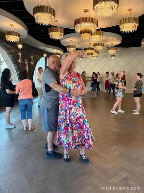 A couple dancing by the arched windows at Tuesday Salsa Nights, The Grand Hall, Chilliwack BC
