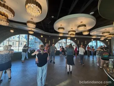 Couples scattered across the dance floor beneath the chandeliers at The Grand Hall, Chilliwack