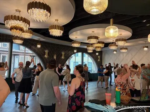 Arms up across a full floor during the lesson at Tuesday Salsa Nights, The Grand Hall, District 1881