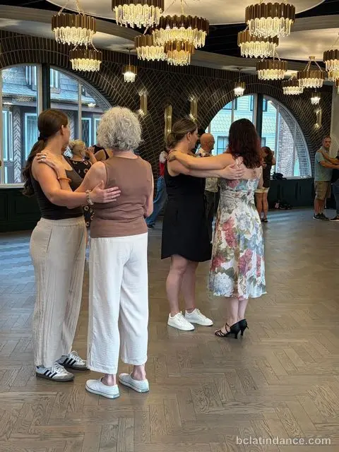 Dancers in close hold facing the arched windows at The Grand Hall, District 1881, Chilliwack