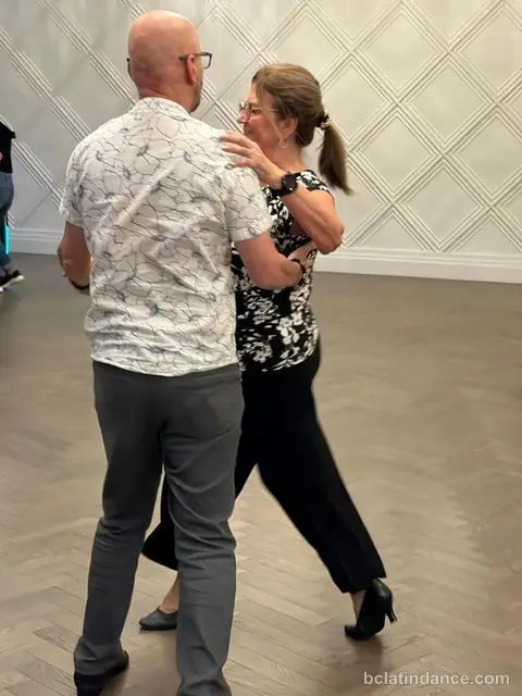 Close hold against the white panelled wall during the social at Tuesday Salsa Nights, The Grand Hall, Chilliwack