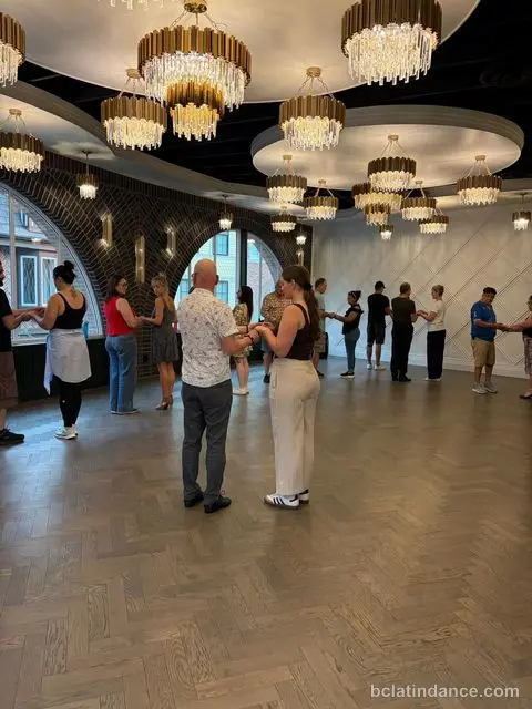 The class forming a wide circle before rotating partners at The Grand Hall, Chilliwack