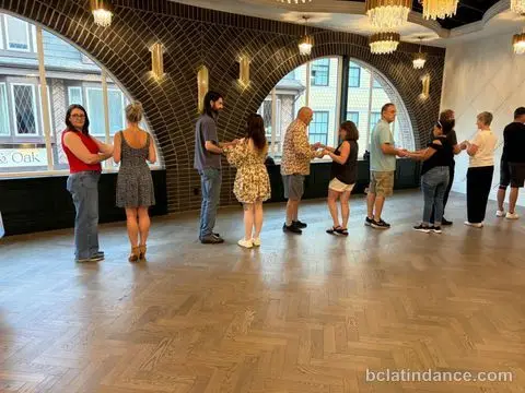 A line of couples in hold along the arched windows at Tuesday Salsa Nights, The Grand Hall, District 1881