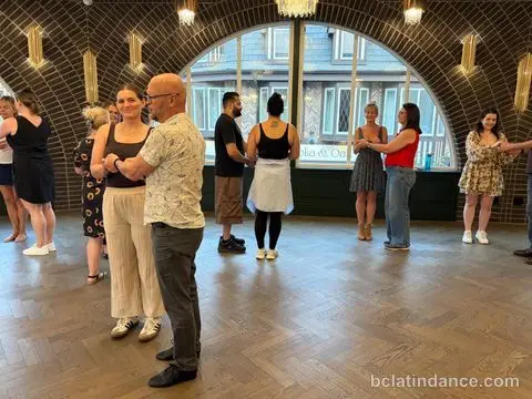 Laughter mid-lesson on a busy floor at Tuesday Salsa Nights, The Grand Hall, Chilliwack