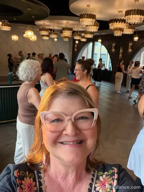 A dancer smiling for the camera with the room behind her at Tuesday Salsa Nights, The Grand Hall, Chilliwack
