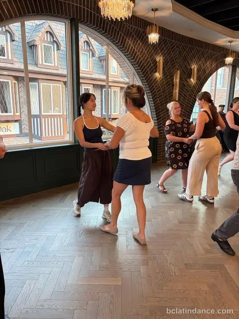 A pair practising the lead by the arched windows overlooking District 1881, The Grand Hall, Chilliwack