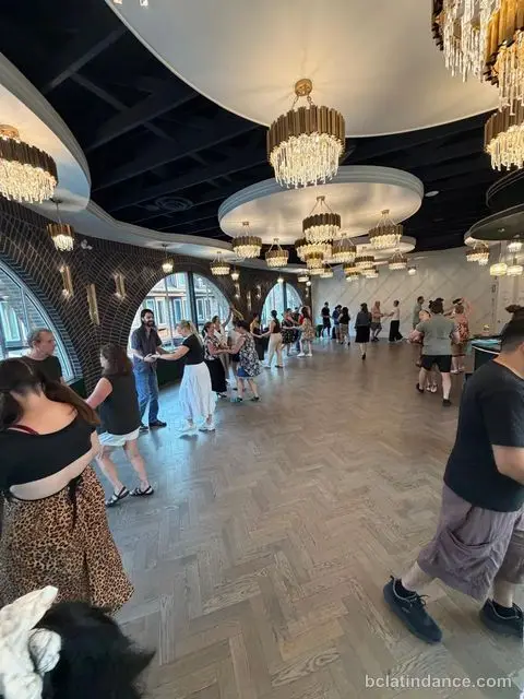 A wide view of the class spread out beneath the chandeliers at The Grand Hall, Chilliwack