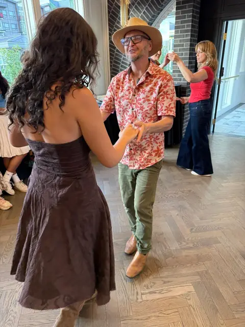 Leading a turn during the social dance hour at The Grand Hall