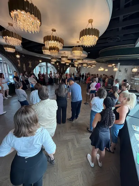A full room gathered round to watch the beginner salsa demonstration at The Grand Hall, District 1881