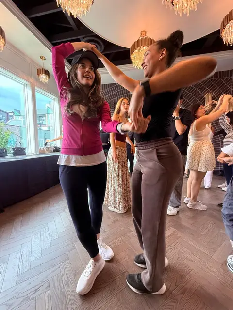 Two dancers working through a turn together at the Tuesday salsa lesson in Chilliwack