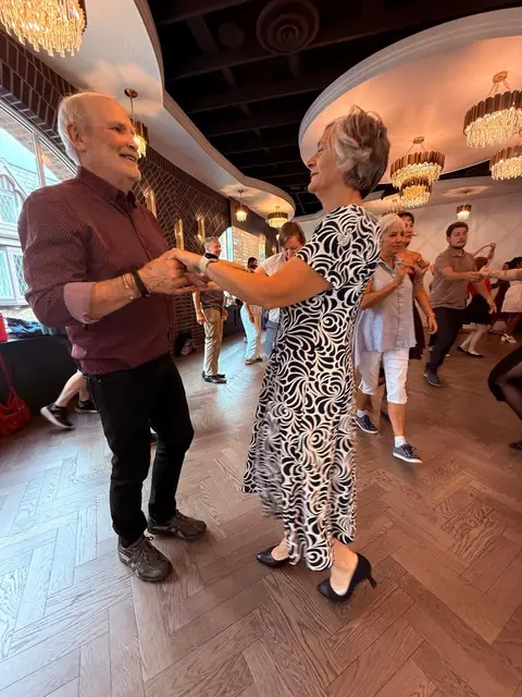 A couple social dancing salsa at The Grand Hall in District 1881