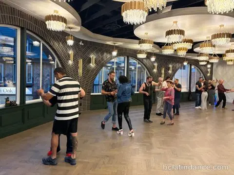 Couples turning across the herringbone floor at Tuesday Salsa Nights, The Grand Hall, Chilliwack
