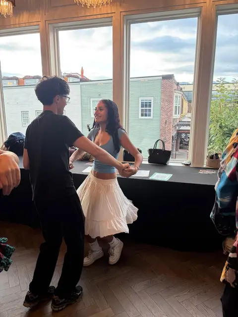 Two young dancers practising a turn by the windows over District 1881, Chilliwack