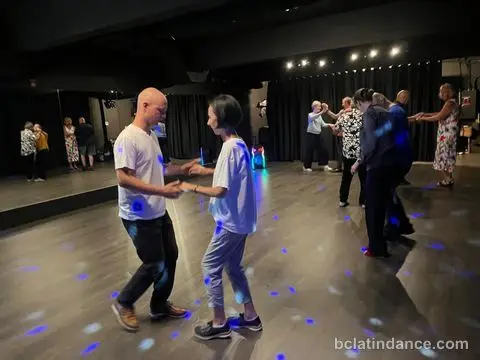 A pair joining hands to start the basic step beside the mirrored wall at Friday Salsa Night, Spencer Studios, Chilliwack