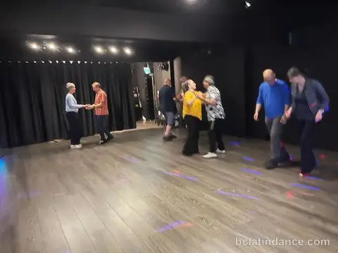 Couples practising the basic step under the disco lights at Friday Salsa Night, Spencer Studios, Chilliwack